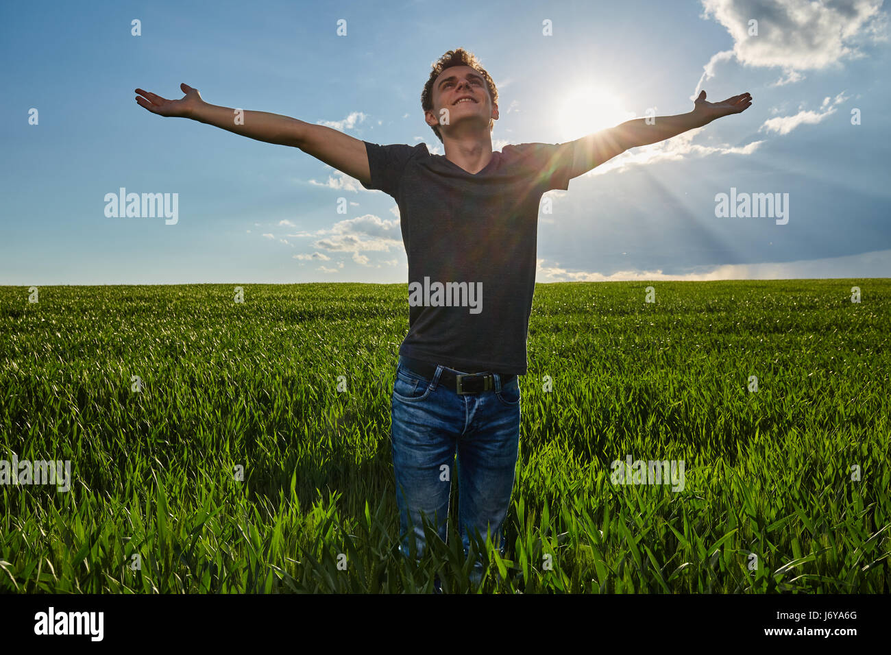 Teenage boy standing in a wheat field at sunset, closeup portrait Stock ...