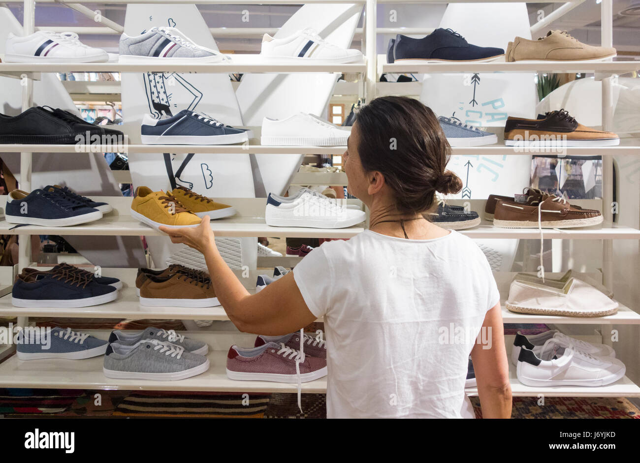 Woman looking at shoes in shop hi-res stock photography and images - Alamy