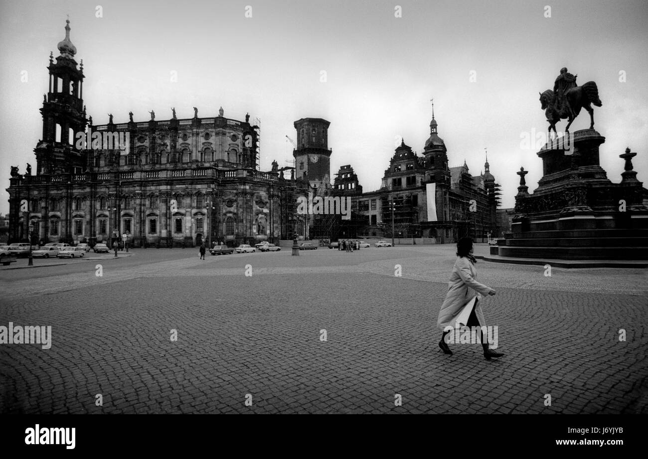 Dresden in what was then East Germany November 1989 The streets of Dresden, Saxony, in former East Germany photographed in the week following the fall of the Wall in Berlin, November 1989. The Catholic Hofkirche is on the left and the ruins of the Residenzschloss is centre the statue is of the Saxon King Johann in front of the Opera House, Semperoper on Theatreplatz Wikipeadia: Dresden has a long history as the capital and royal residence for the Electors and Kings of Saxony, who for centuries furnished the city with cultural and artistic splendour. The city was known as the Jewel Box, because Stock Photo