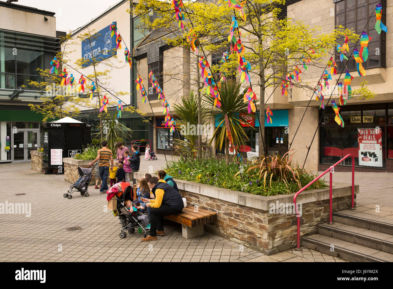 UK, Cornwall, St Austell, White River Place shopping development, shoppers resting in