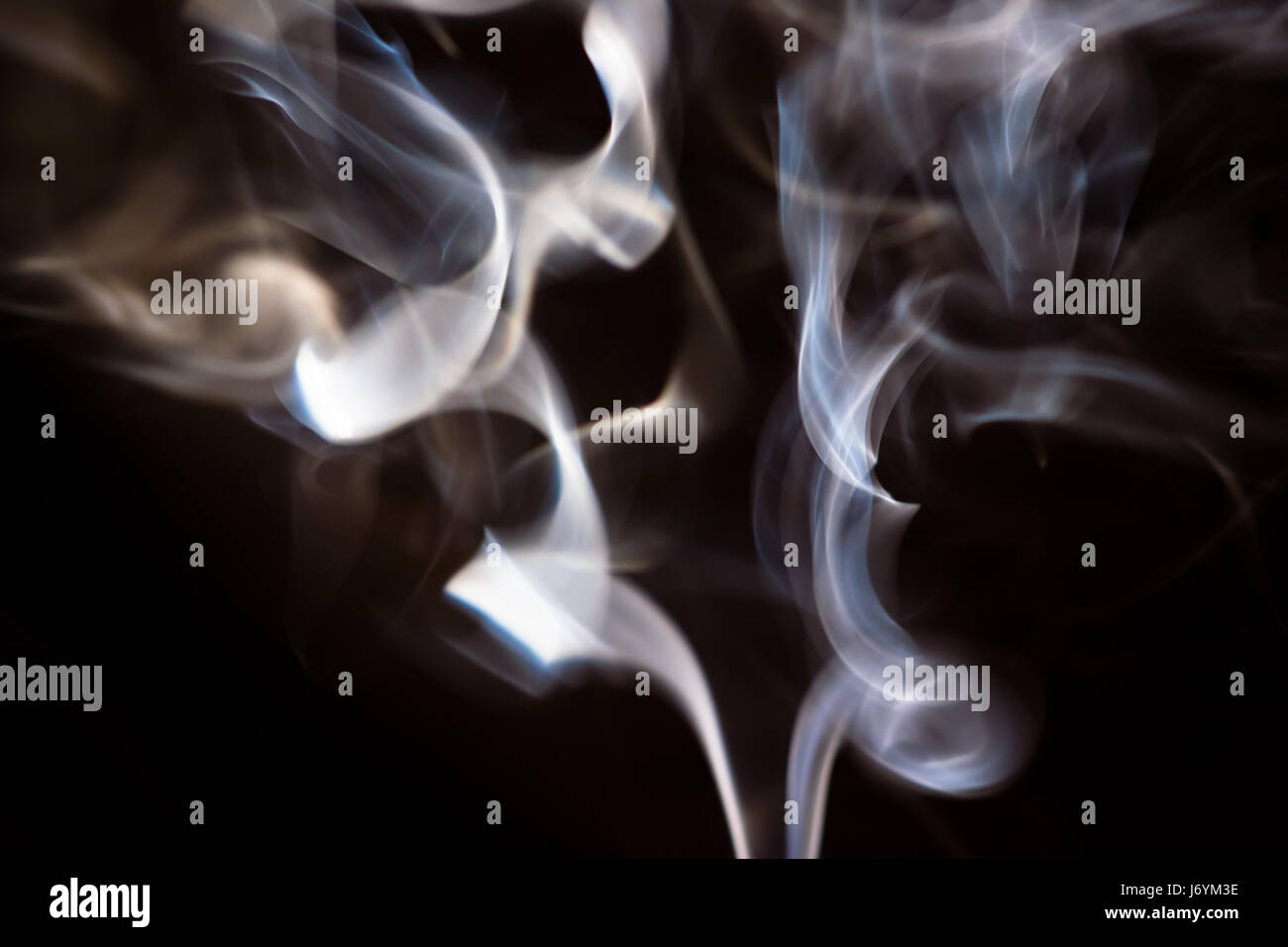 white smoke on a black background Stock Photo - Alamy