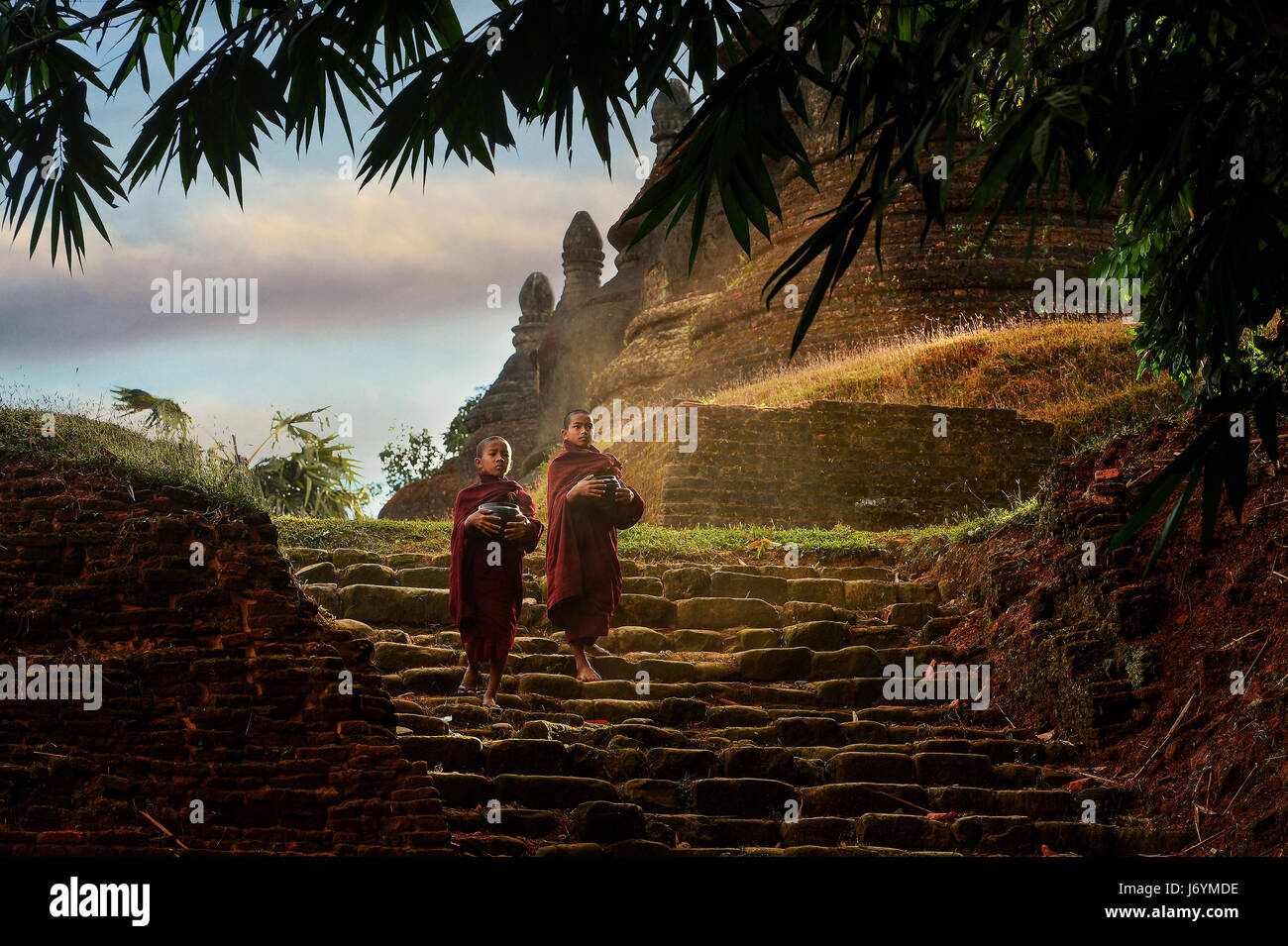Novice monks in the plain of mrauk-u Ratanabon Paya on during sunrise, Mrauk-u Myanmar ancient, Myanmar religion, Stock Photo