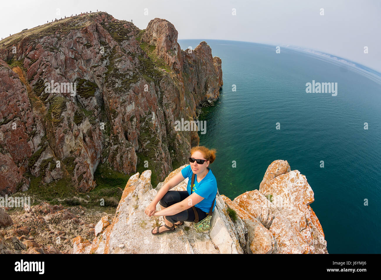 Girl sitting on edge cliff hi-res stock photography and images - Alamy