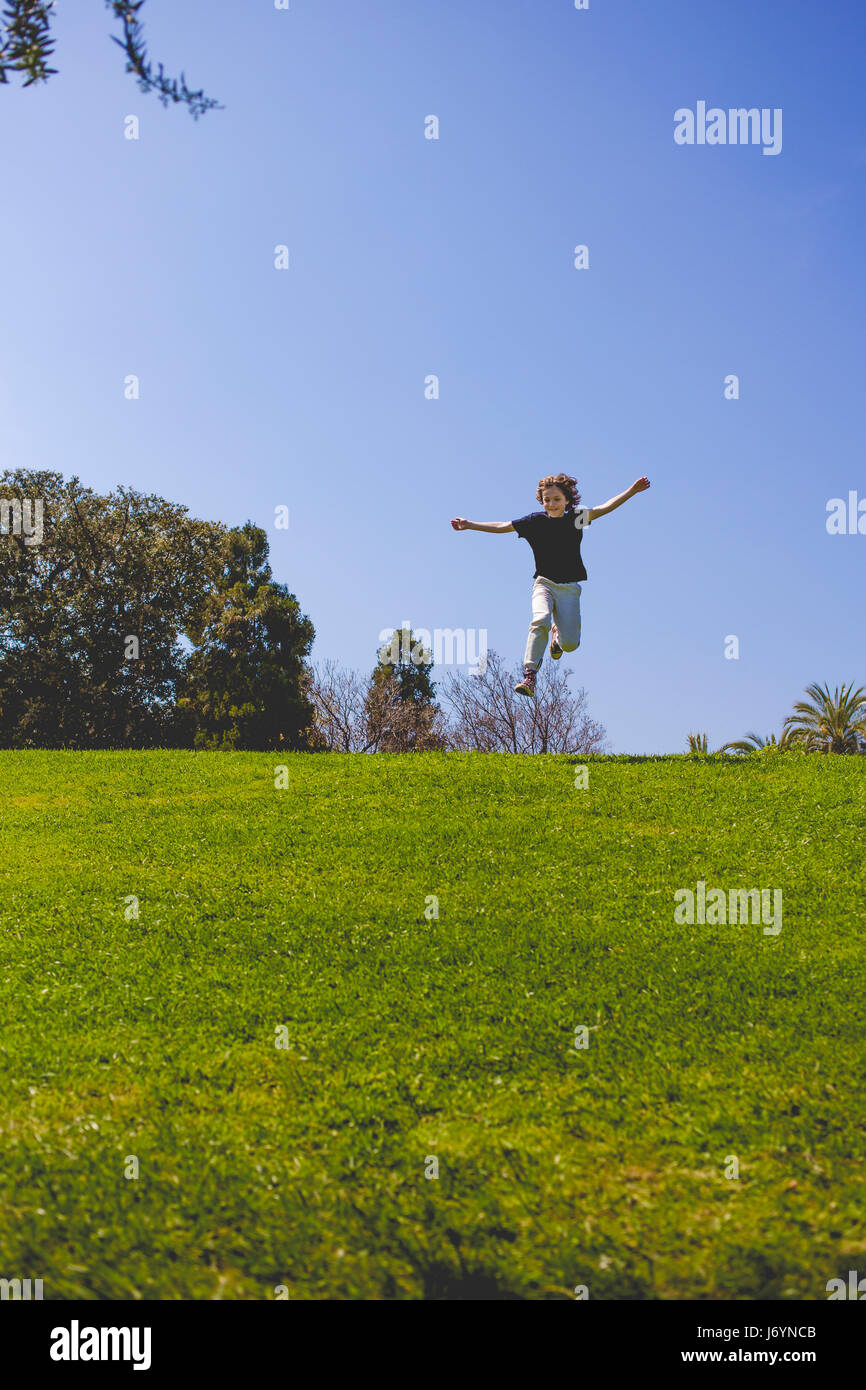 Boy jumping in the park, Barcelona, Spain Stock Photo - Alamy