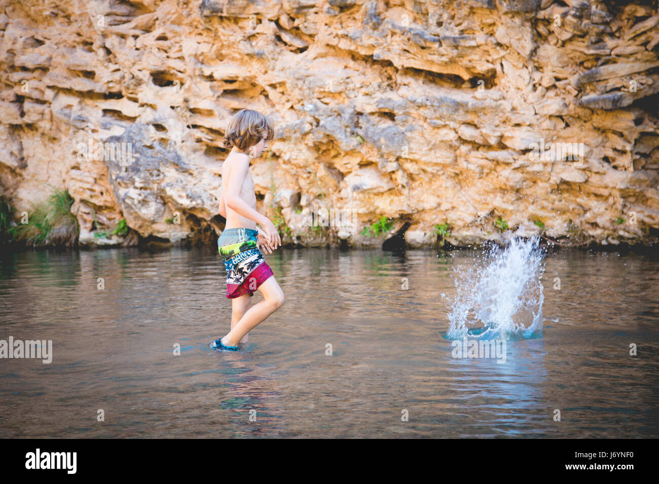 Children throwing stones hi-res stock photography and images - Alamy