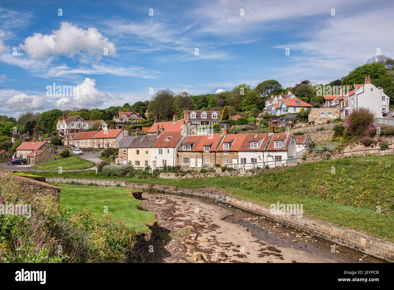 The village of Sandsend, near Whitby, North Yorkshire, England, UK, on a fine spring day with sunshine and blue sky. Stock Photo