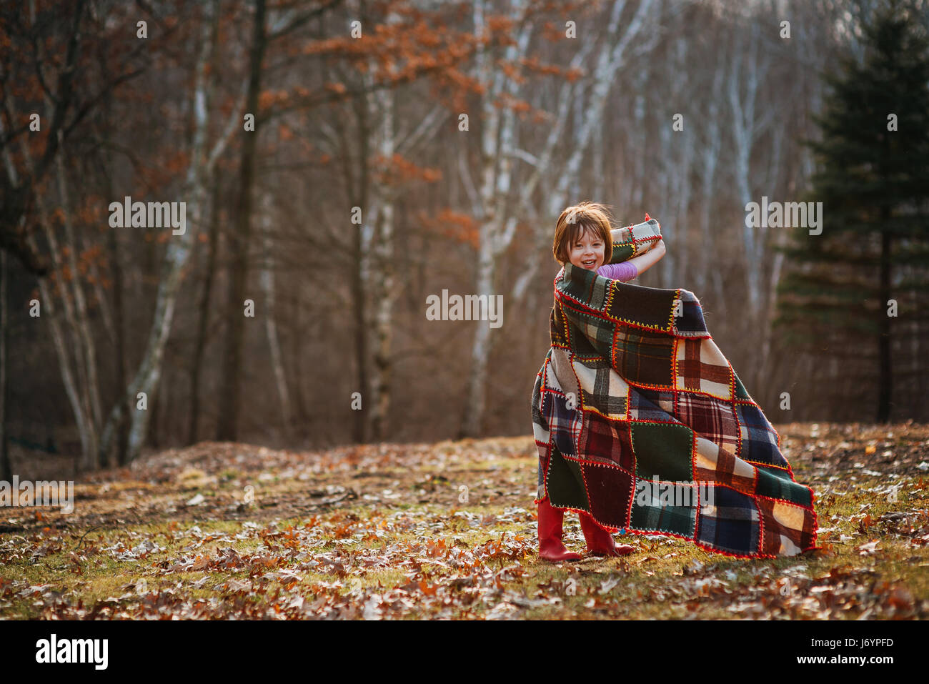 Girl wrapped in a blanket spinning around Stock Photo