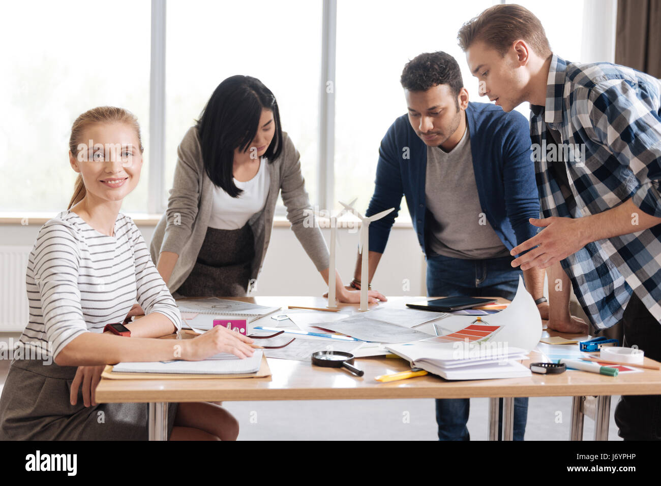 Attractive pleasant woman sitting at the table Stock Photo - Alamy