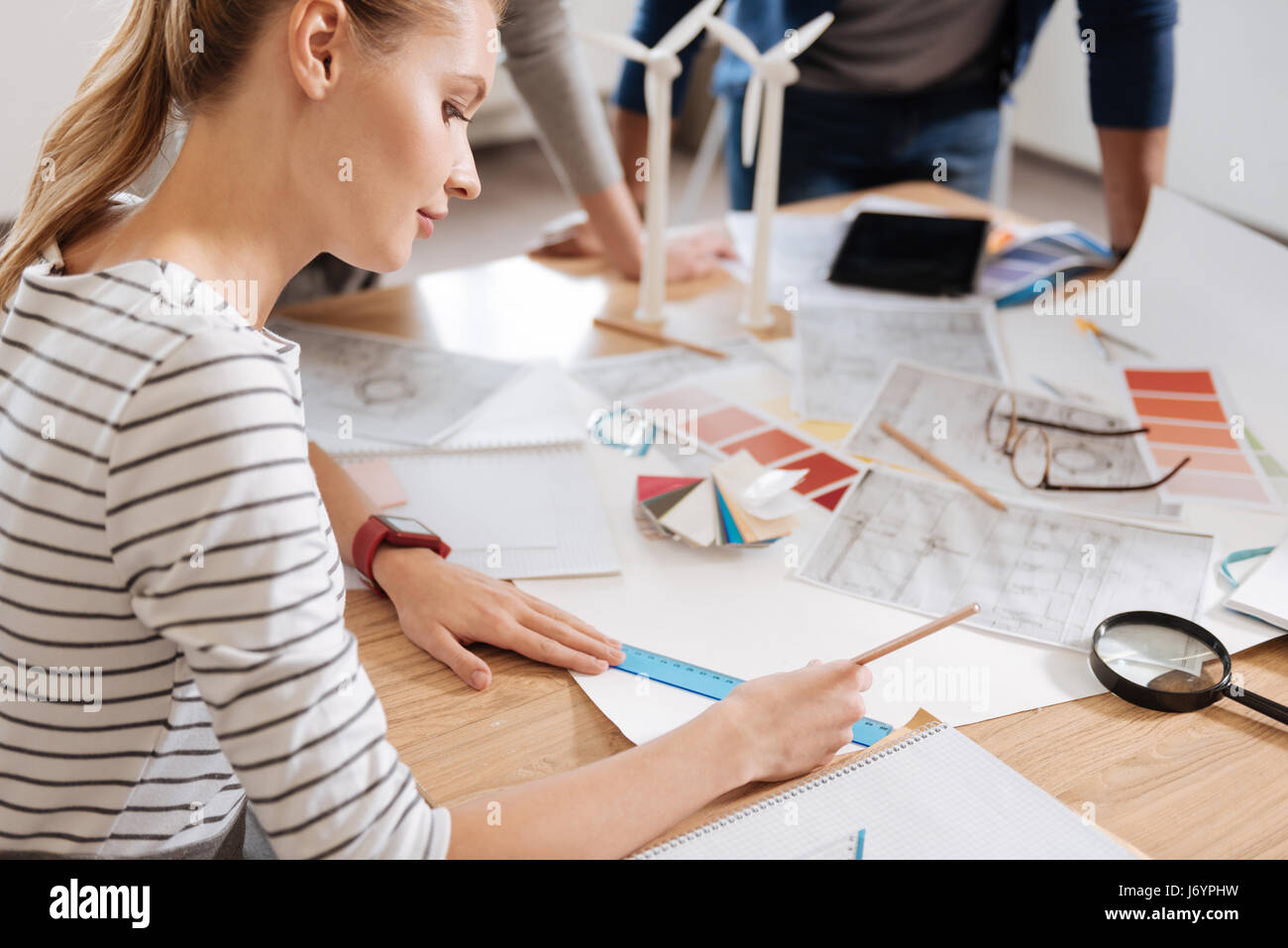 Serious hard working woman doing a drawing Stock Photo