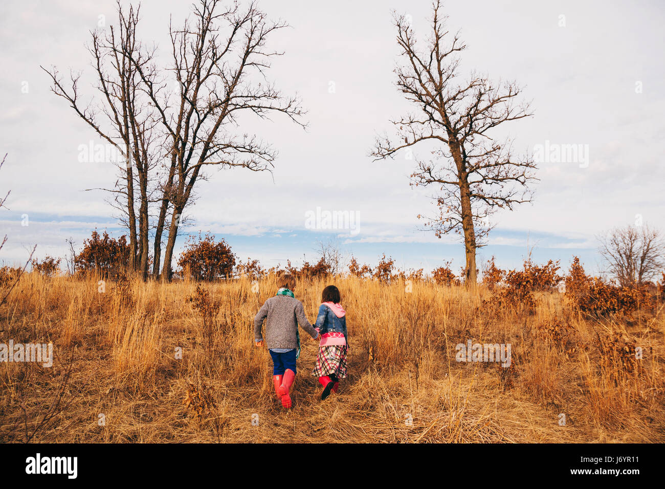 Boy and girl holding hands hi-res stock photography and images - Alamy