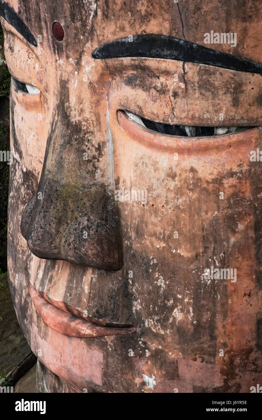 Close up of the Leshan Giant Buddha is a 71-meter, 233 ft tall stone statue. Built between 713 and 803 during the Tang Dynasty. It is carved out of a  Stock Photo