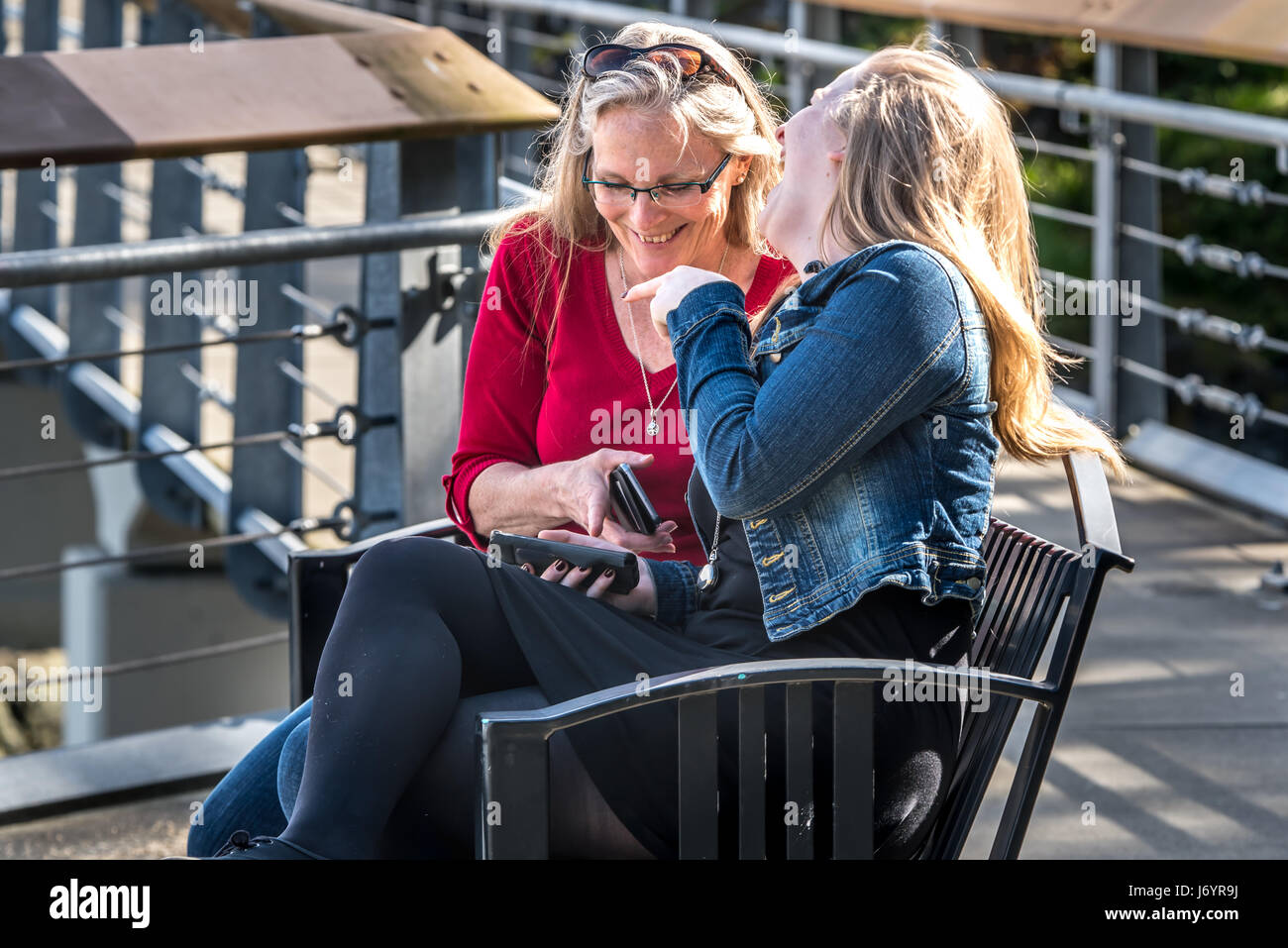 Mother and daughter looking at something funny on a mobile phone Stock Photo