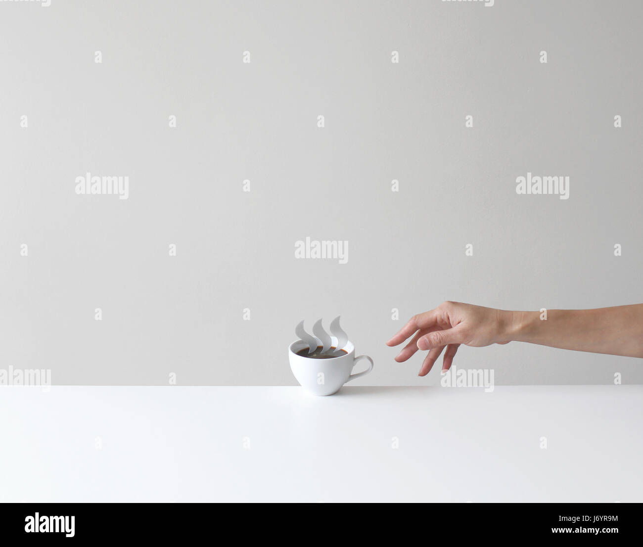 Hand reaching for a conceptual cup of coffee Stock Photo