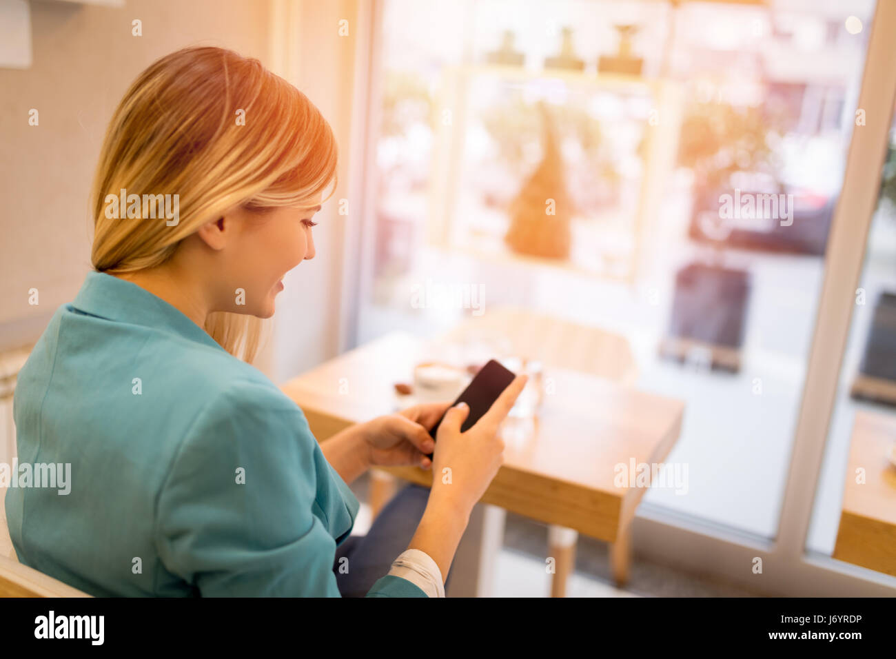 Woman reading phone rear view hi-res stock photography and images - Alamy