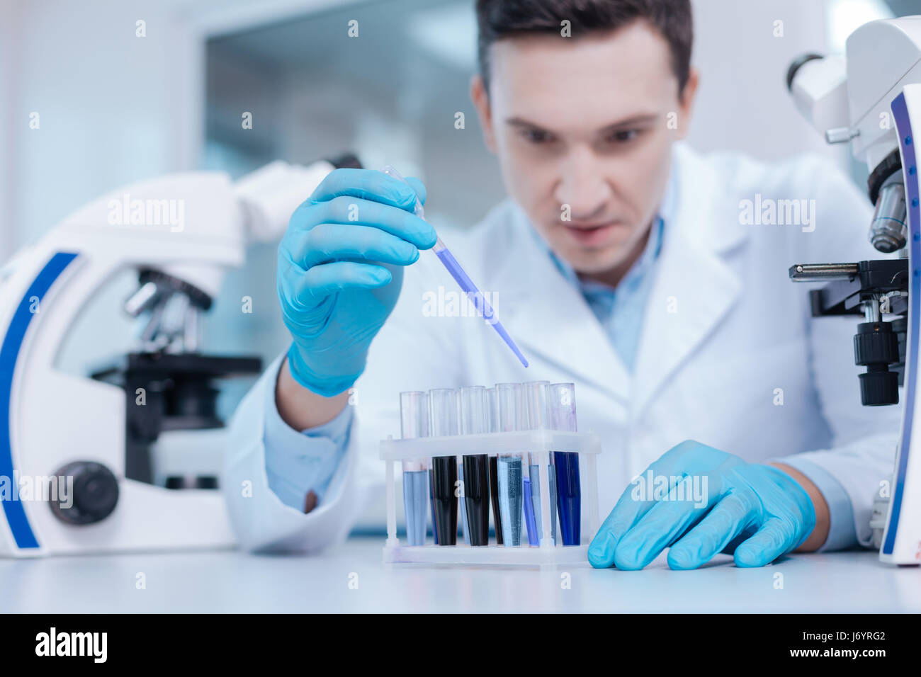 Very attentive practitioner examining chemical agents Stock Photo