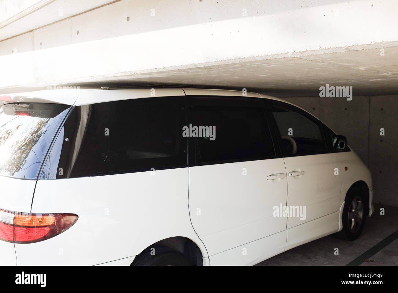 A white car parked with great precision. Stock Photo
