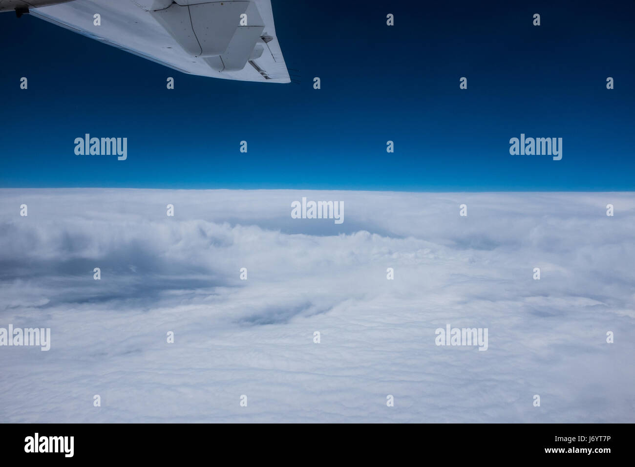 Jet wing flying over the clouds Stock Photo Alamy