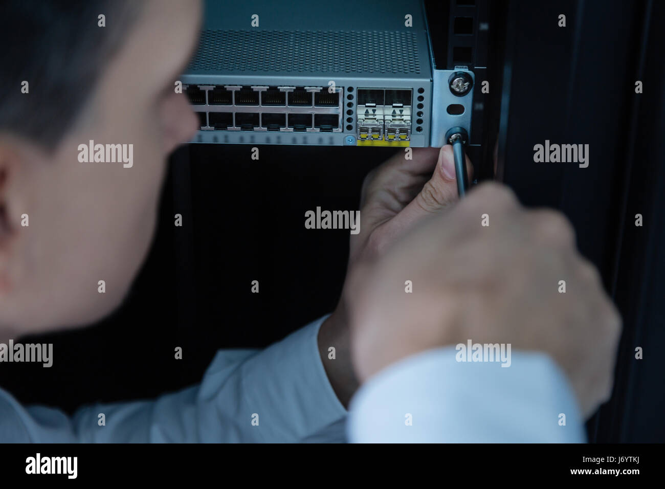 Handsome experienced technician repairing the rack server repair Stock ...