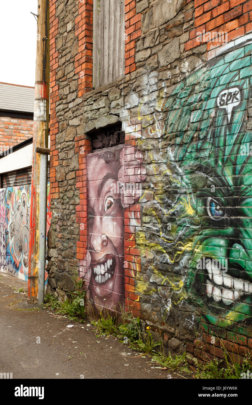 back alley street art behind railings. Stock Photo