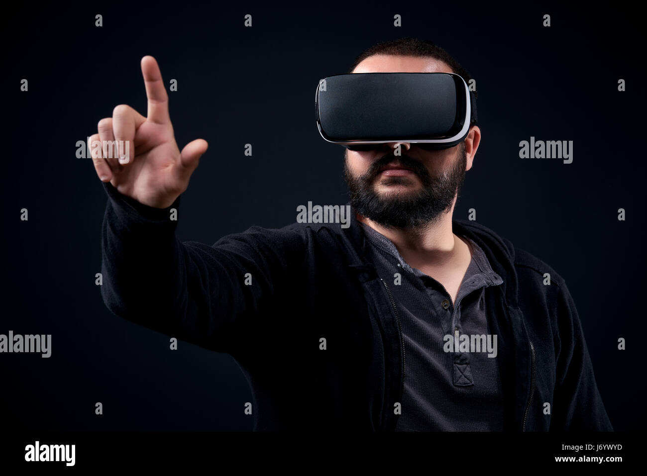 Young hipster bearded man wearing virtual reality goggles. Black ...