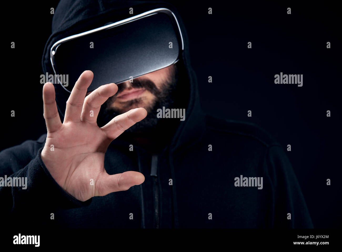 Young hipster bearded man wearing virtual reality goggles. Black ...