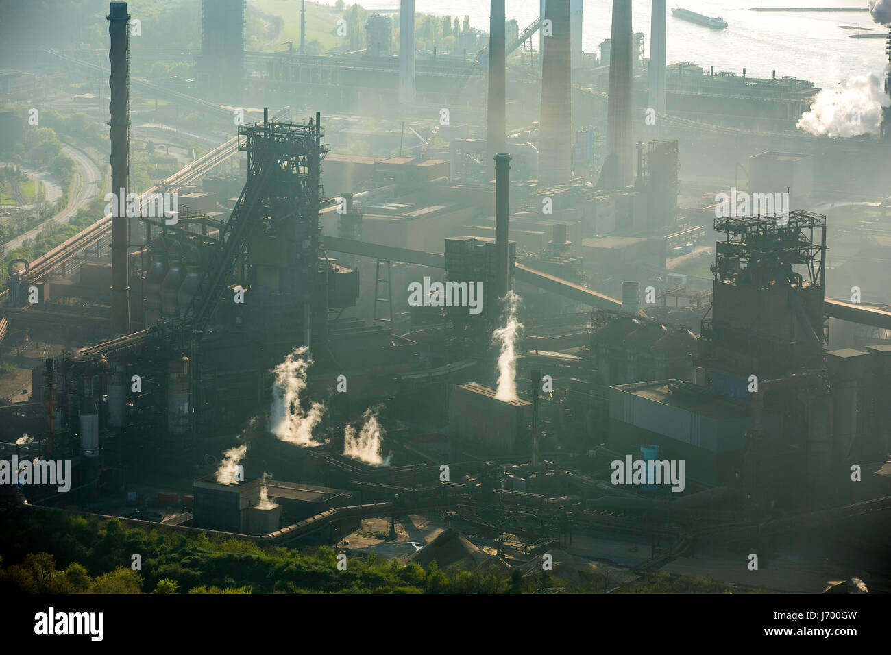 Steelworks ThyssenSteel, steel industry, heavy industry, mining industry, air pollution, emissions, chimneys, Rhine arc, river, haze, dust, blast fu Stock Photo