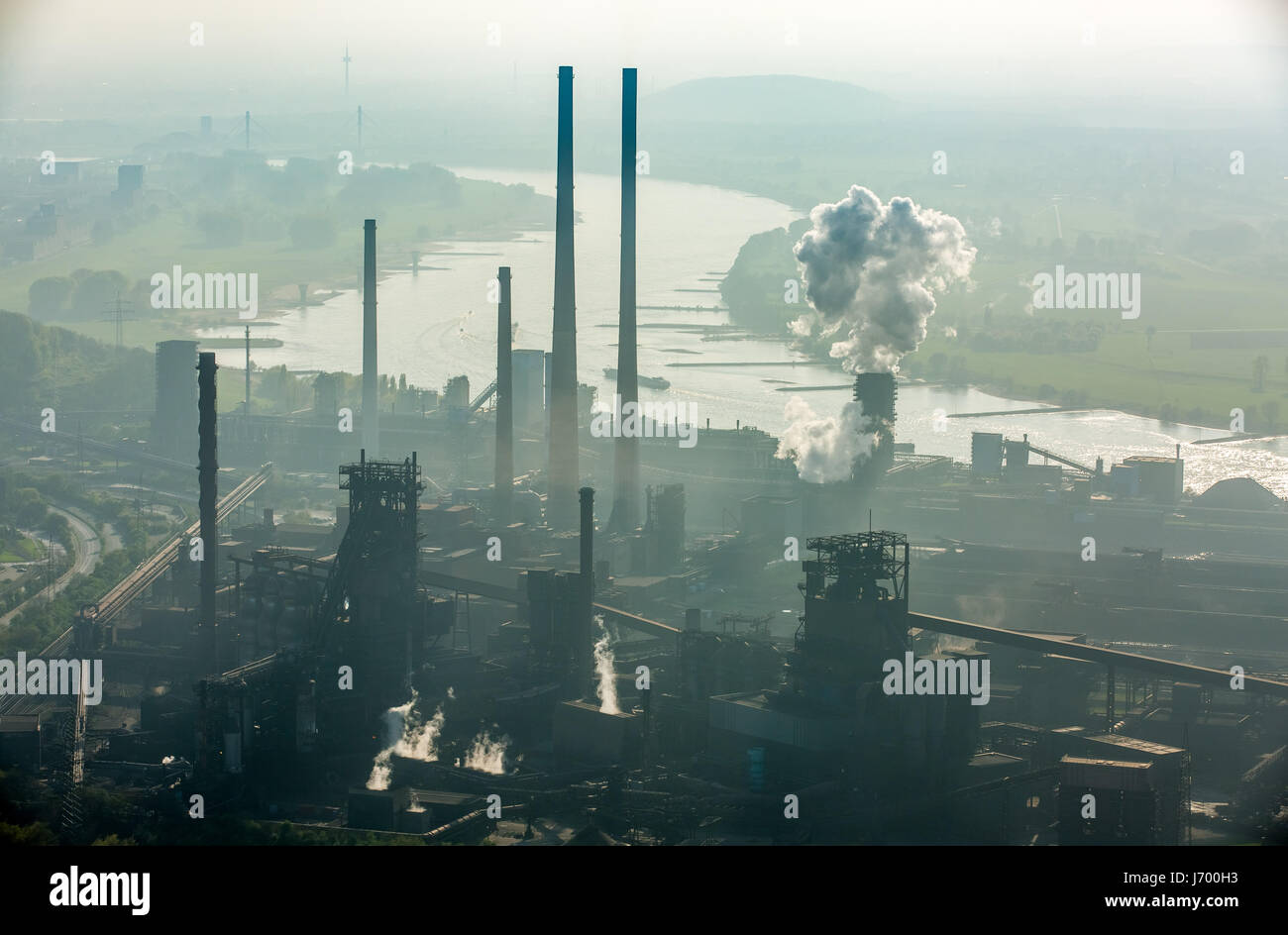 Steelworks ThyssenSteel, steel industry, heavy industry, mining industry, air pollution, emissions, chimneys, Rhine arc, river, haze, dust, blast fu Stock Photo