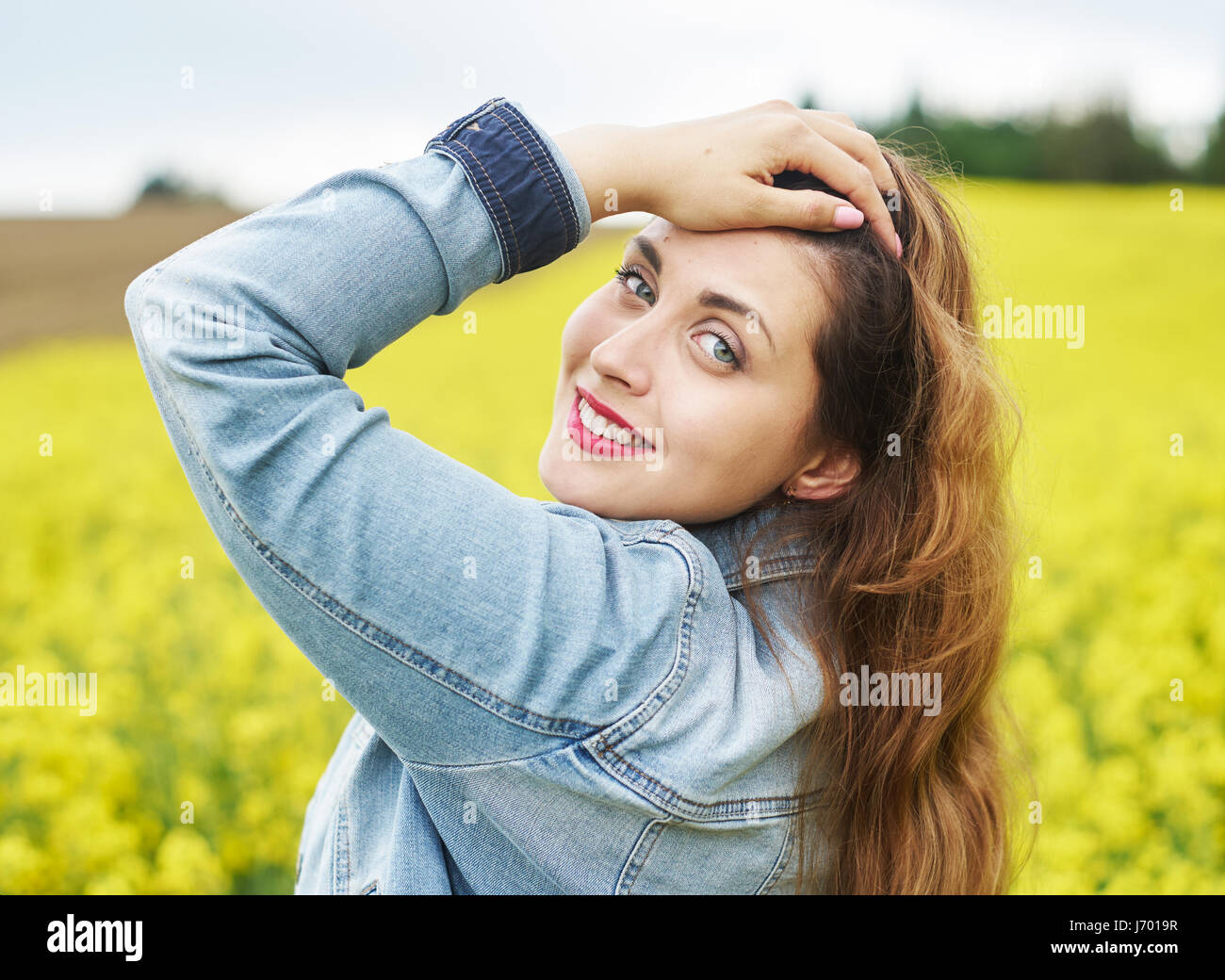 A portrait of woman in rapeseed field Stock Photo - Alamy
