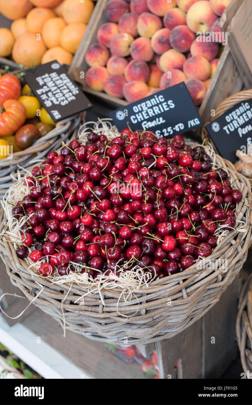 Organic fruit, cherries, for sale at Daylesford Organic farm shop summer festival. Daylesford, Cotswolds, Gloucestershire, England Stock Photo