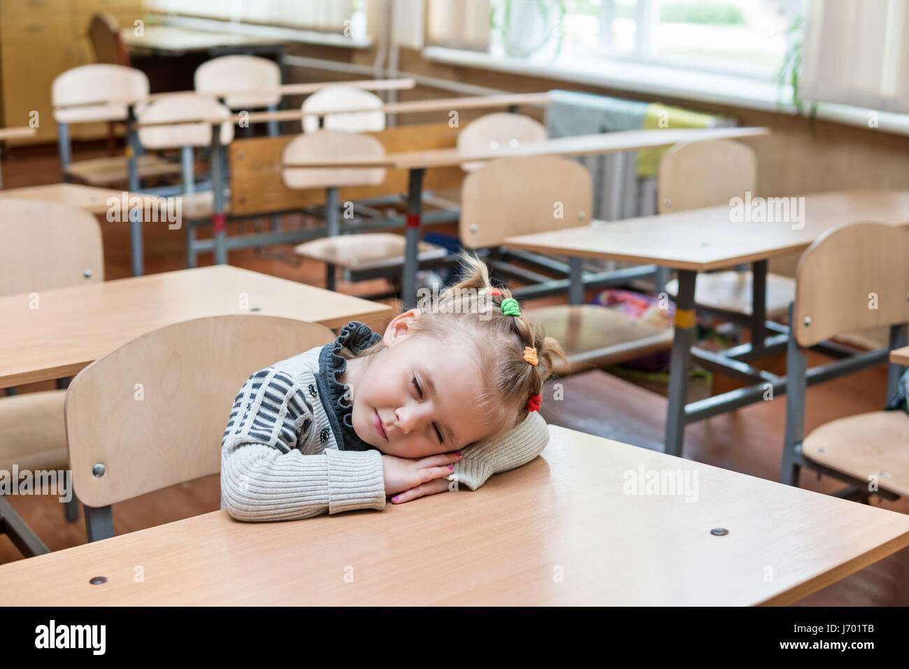Schoolgirl asleep at his desk Stock Photo - Alamy