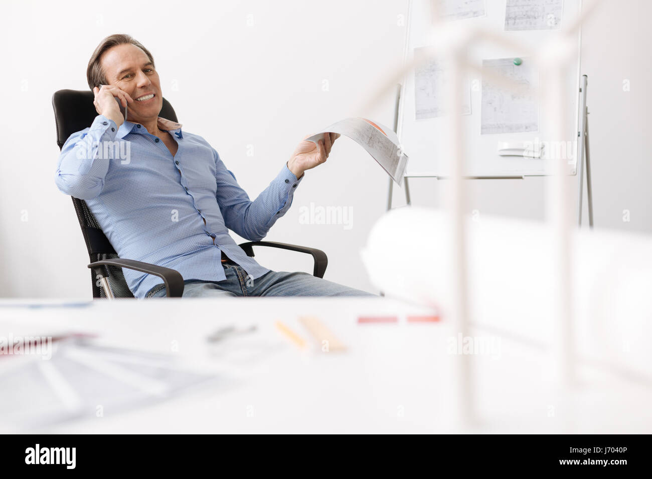 Positive engineer sitting in the office Stock Photo