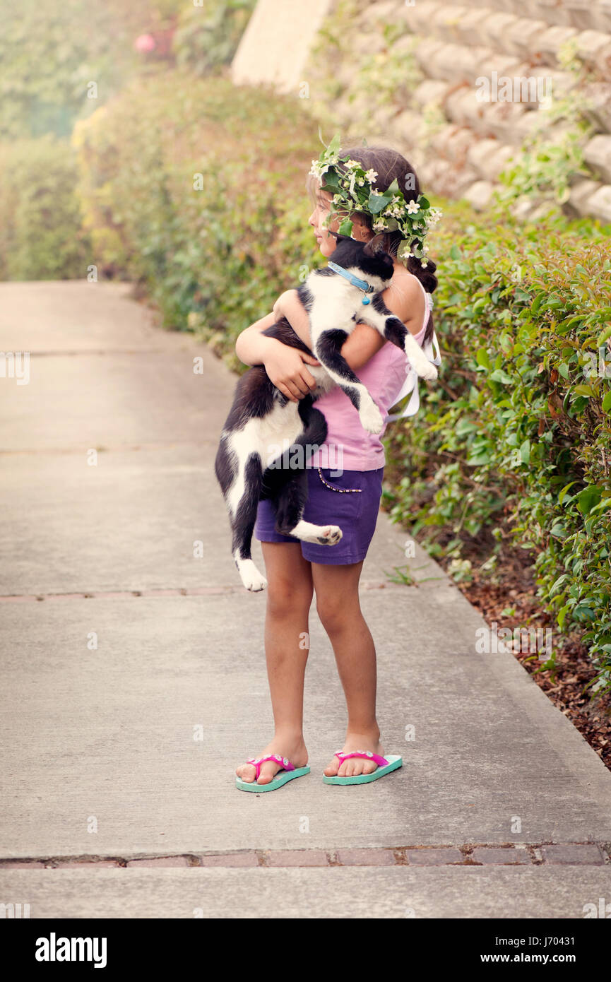 Child holding  cat outside Stock Photo