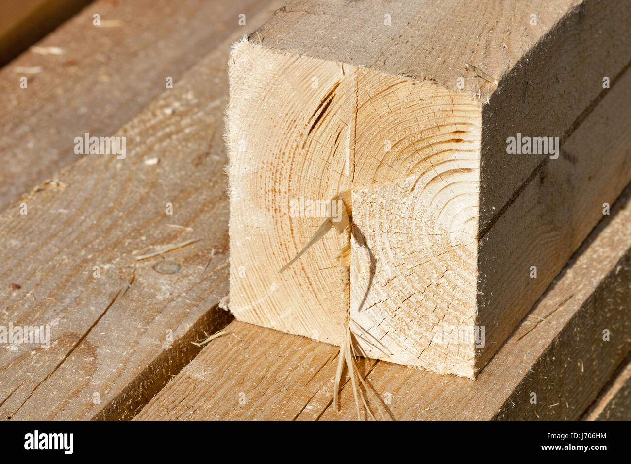 Pile of rectangular and quadratic wooden beams in the construction site, closeup. Stock Photo