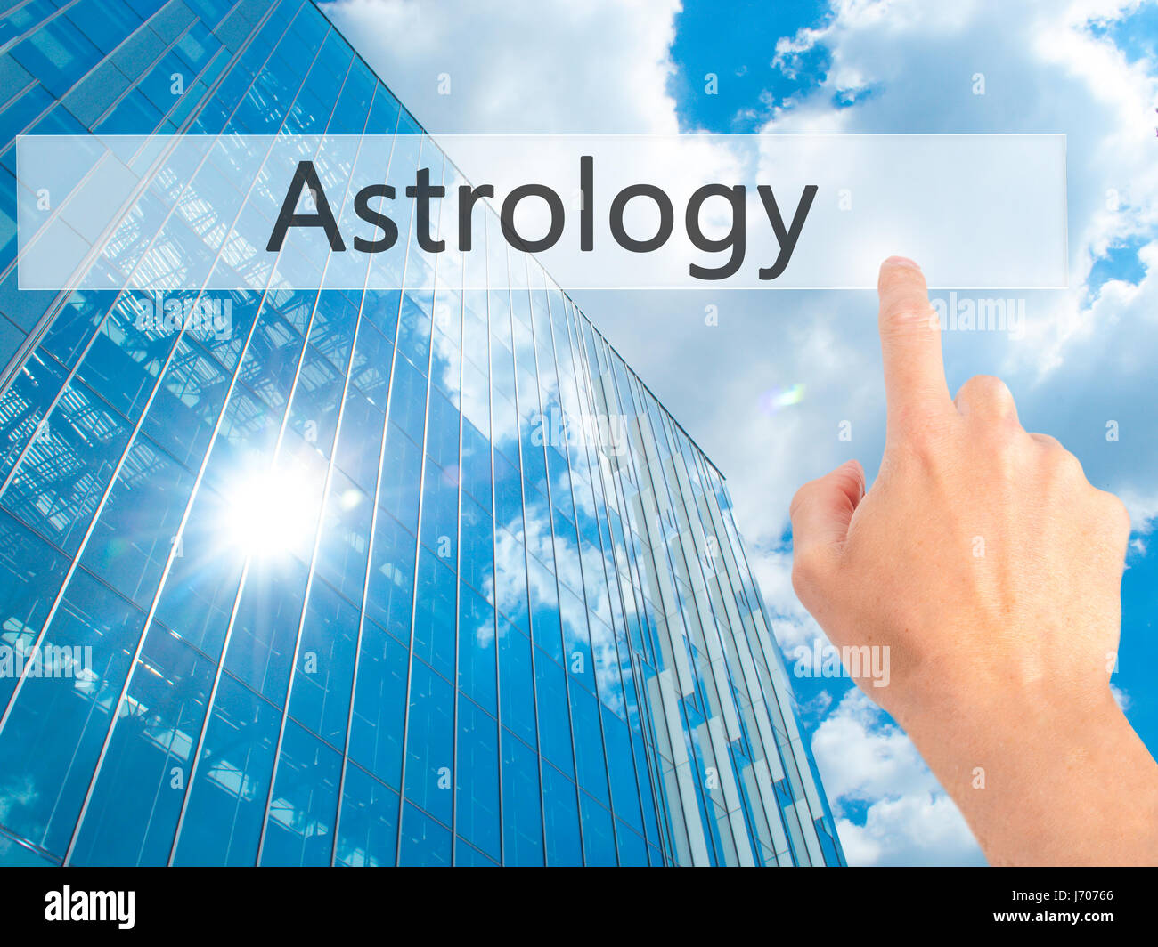Astrology - Hand pressing a button on blurred background concept . Business, technology, internet concept. Stock Photo Stock Photo