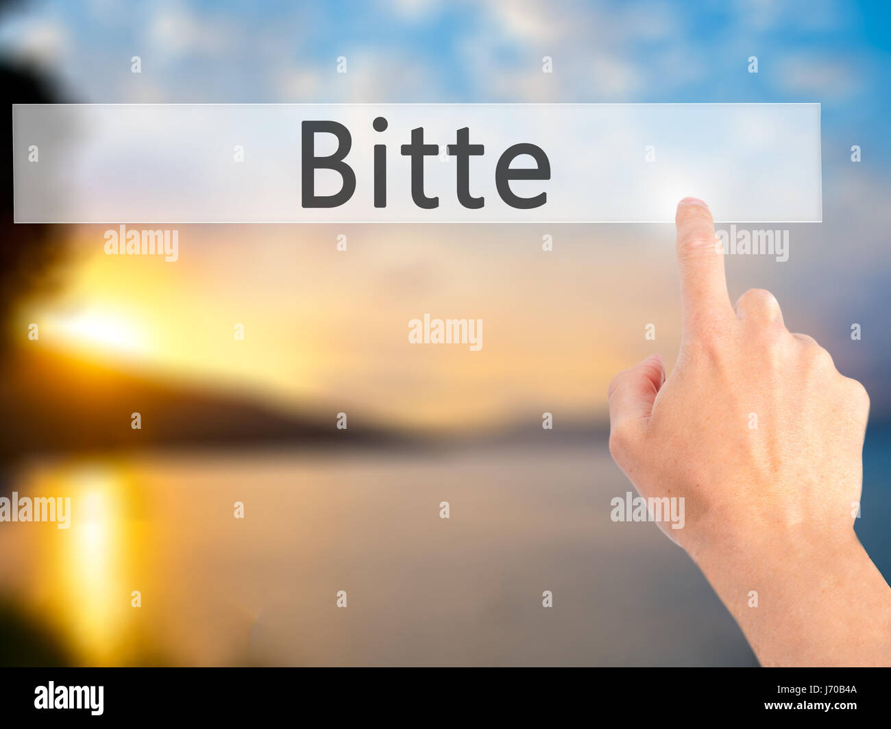 Bitte (Please in German) - Hand pressing a button on blurred background ...