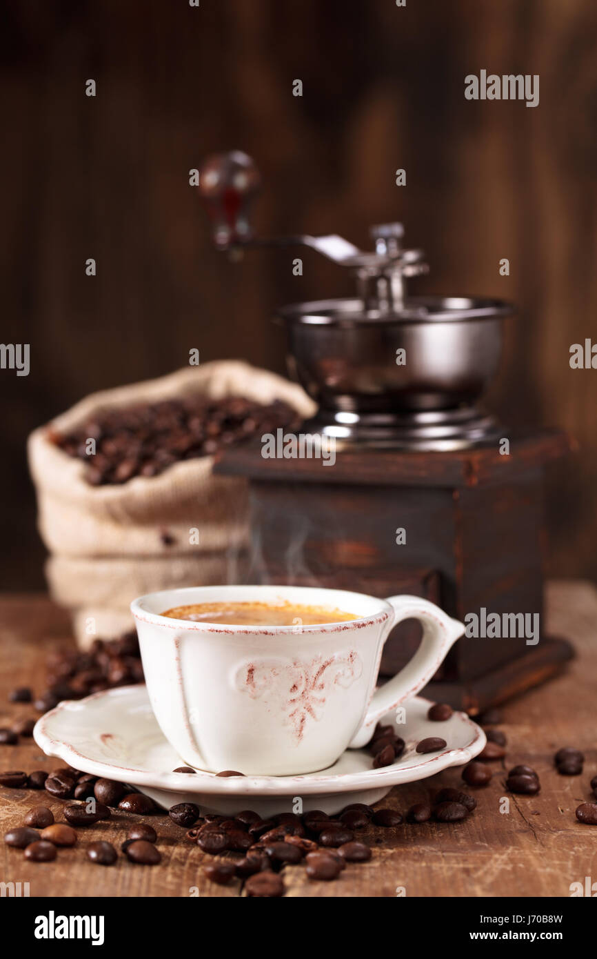 Cup of coffee and coffee beans on wooden table  . Stock Photo