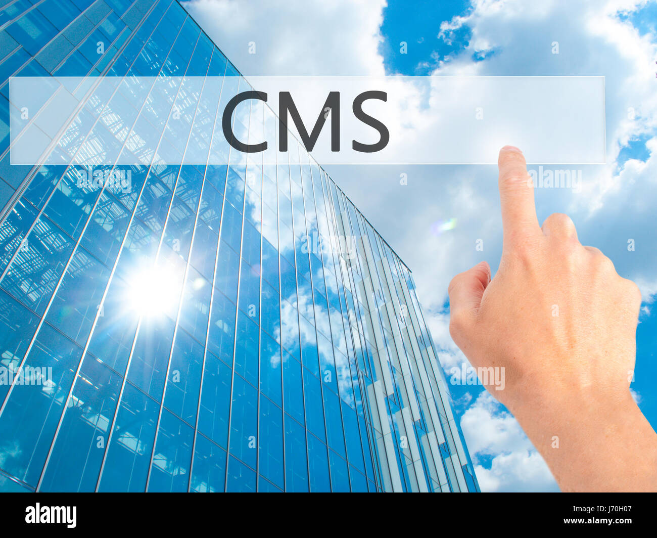 CMS - Hand pressing a button on blurred background concept . Business ...