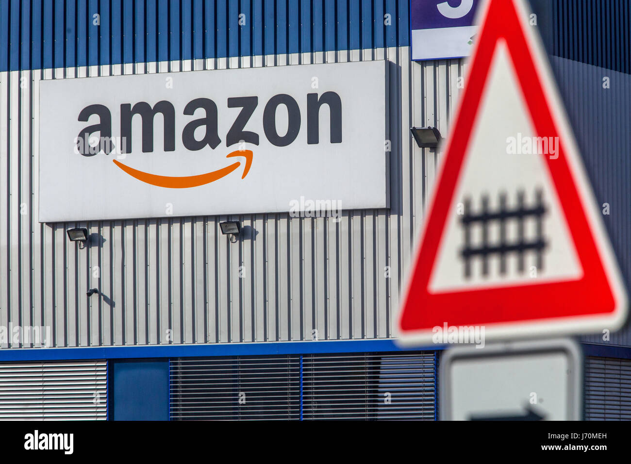 Amazon logo, sign, and marker alerted to the railroad crossing. Dobroviz, Czech Republic, Europe Stock Photo
