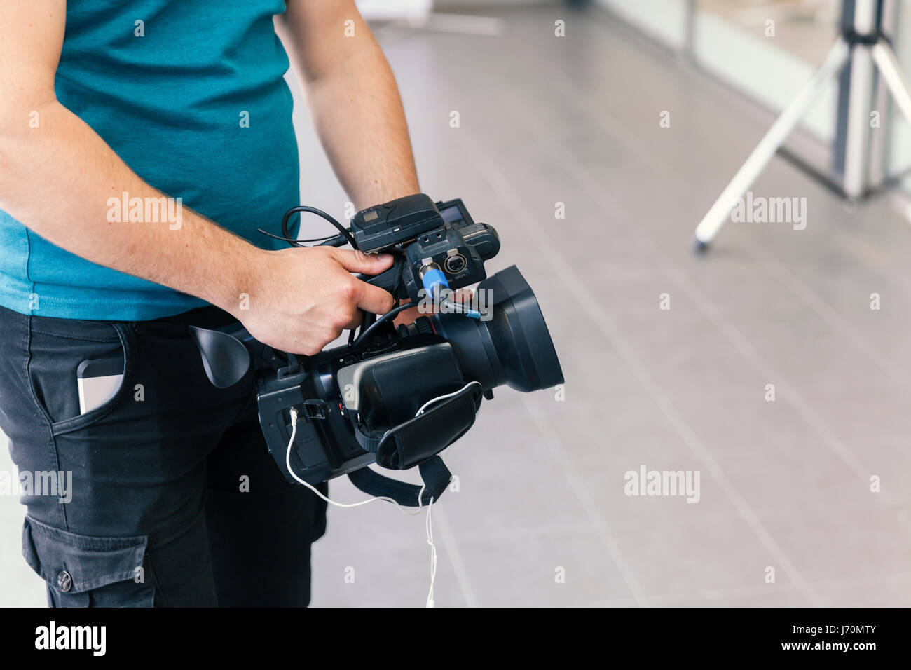 cameraman shooting with handheld camera Stock Photo