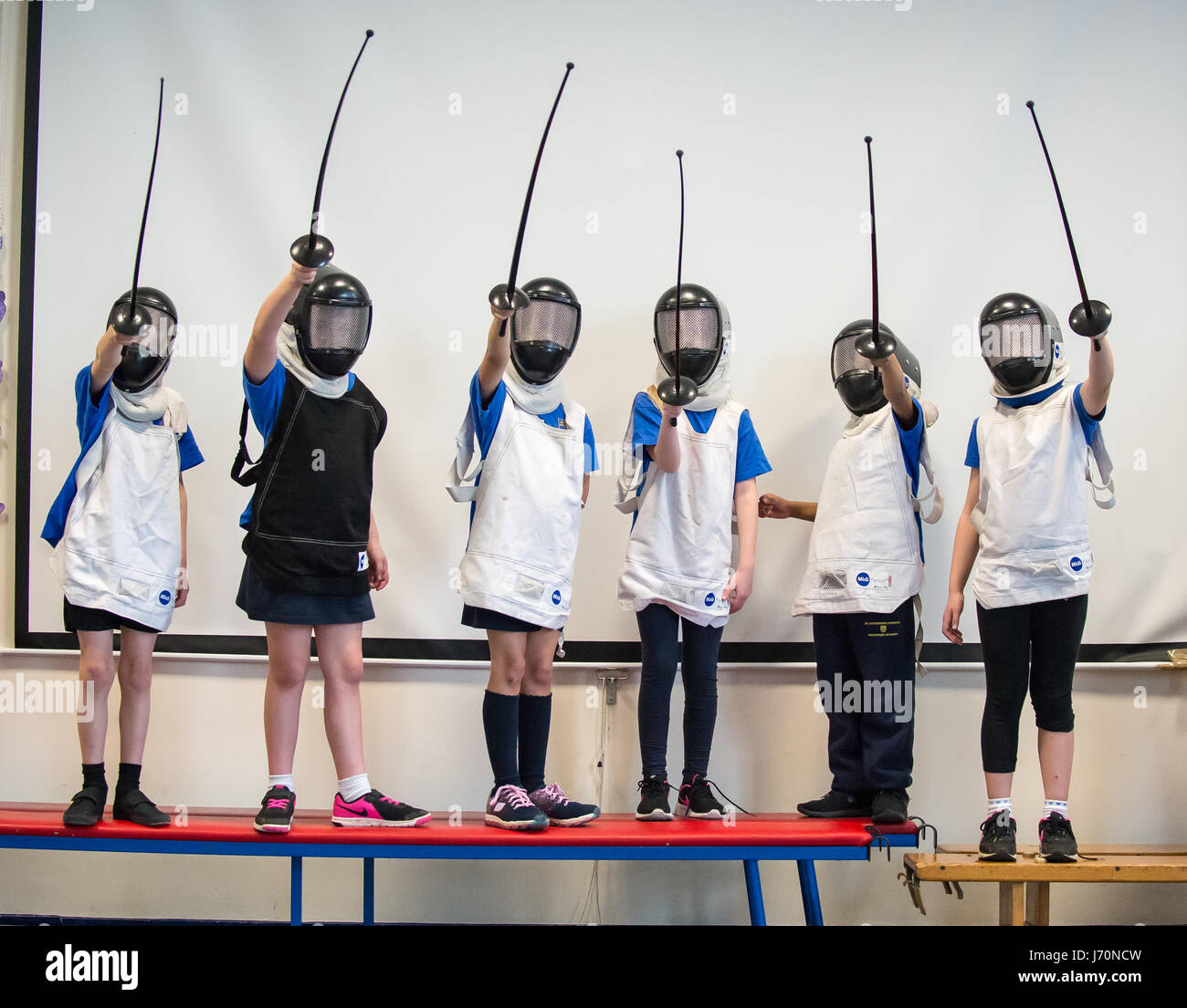 Children in a primary school learning to fence Stock Photo