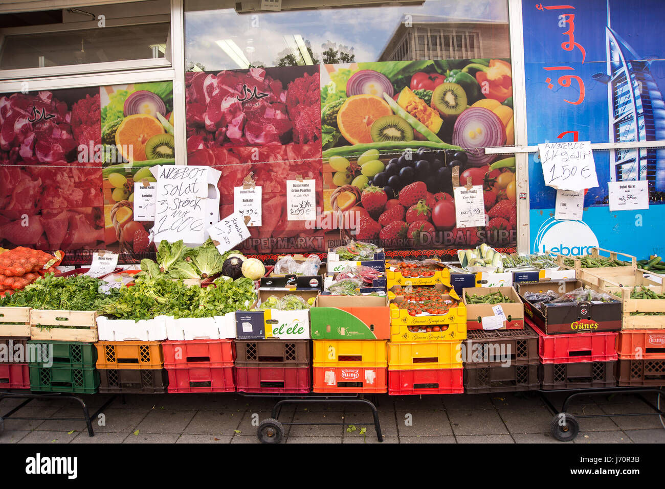 Produce in crates for sale outside a store with signs in arab Stock