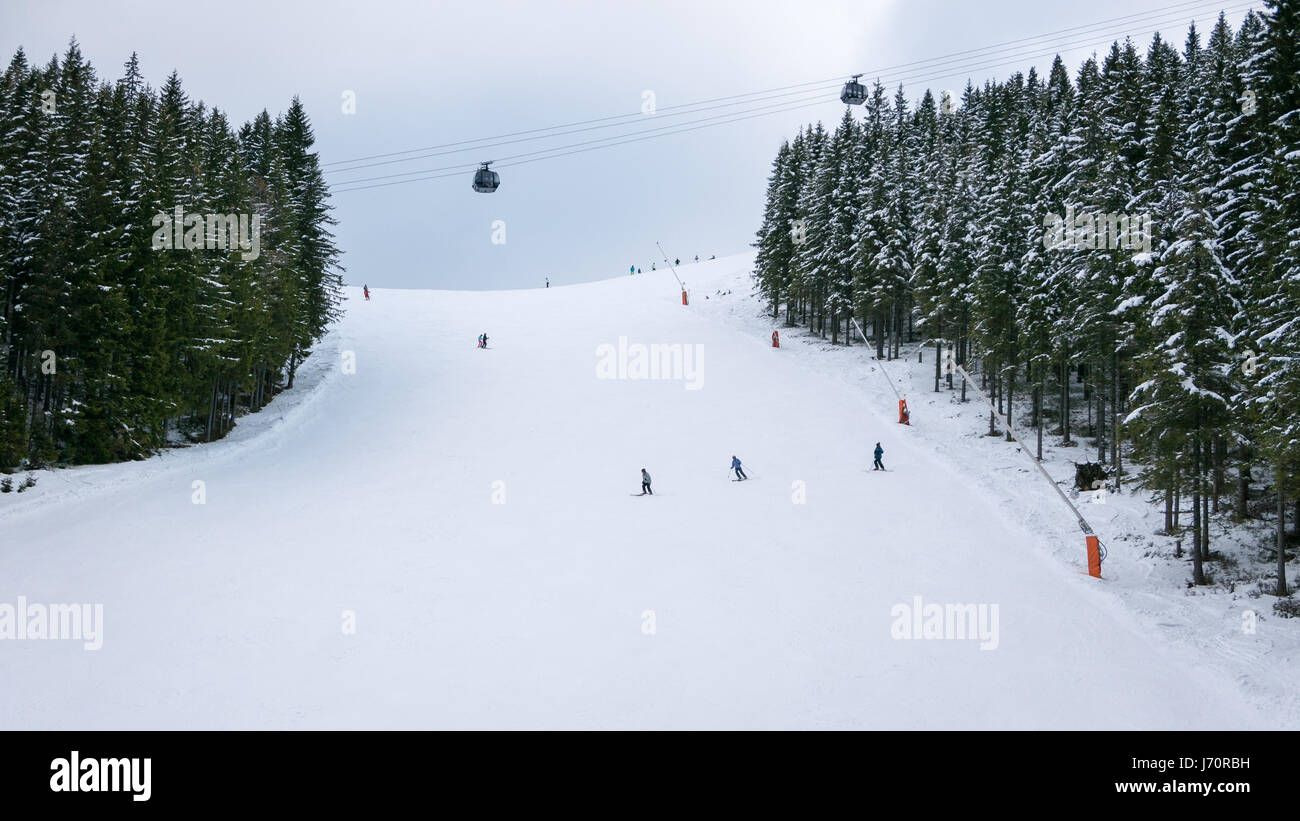 Skiers and snowboarders riding on a ski slope in Jasna Chopok in Slovakia ski resort. Stock Photo