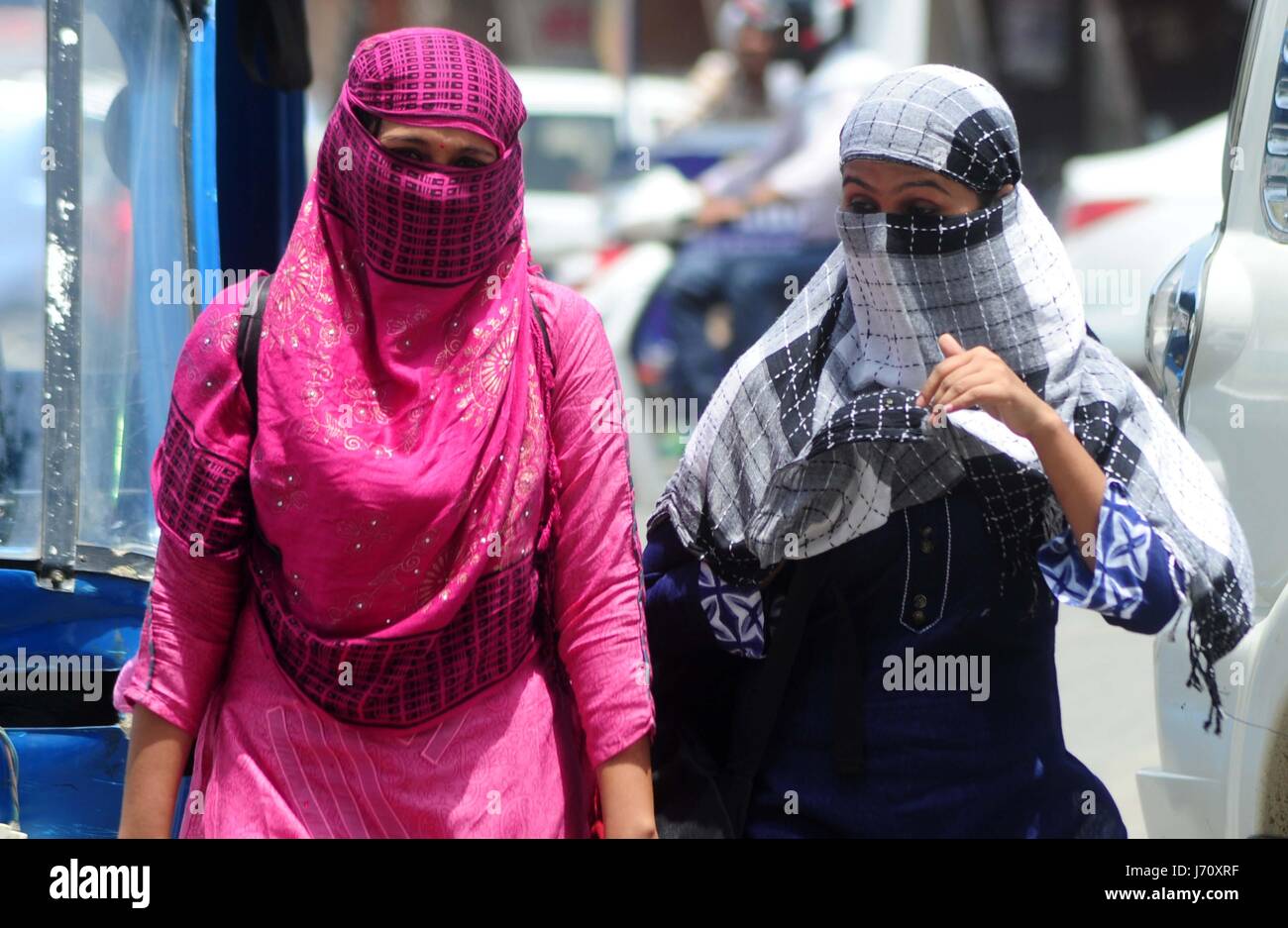 Girls cover their face with scarf to being safe with scorching heat ...