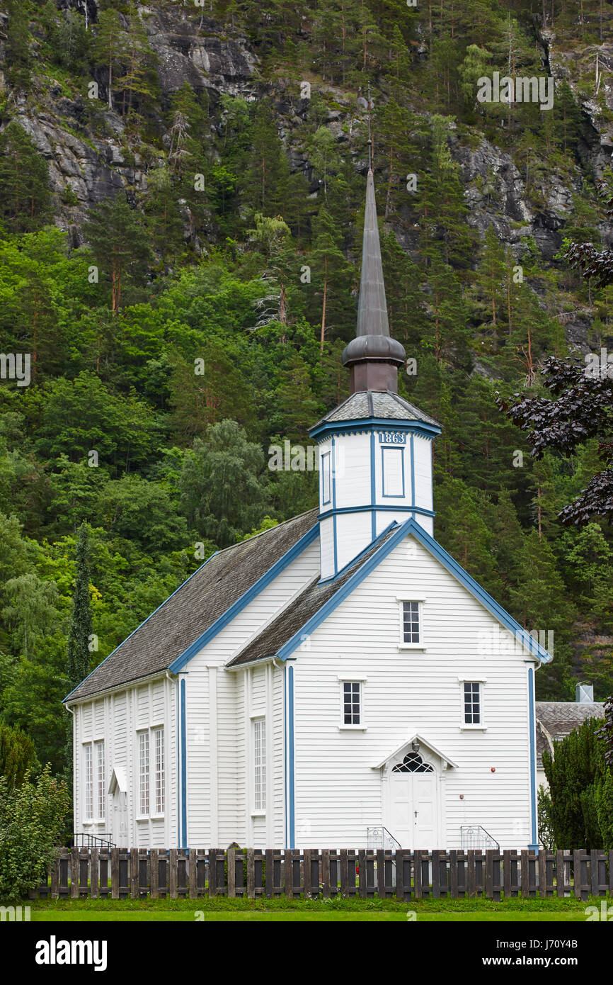 Traditional norwegian white stave church. Valldal Sylte stavkyrkje. Travel Norway. Vertical Stock Photo