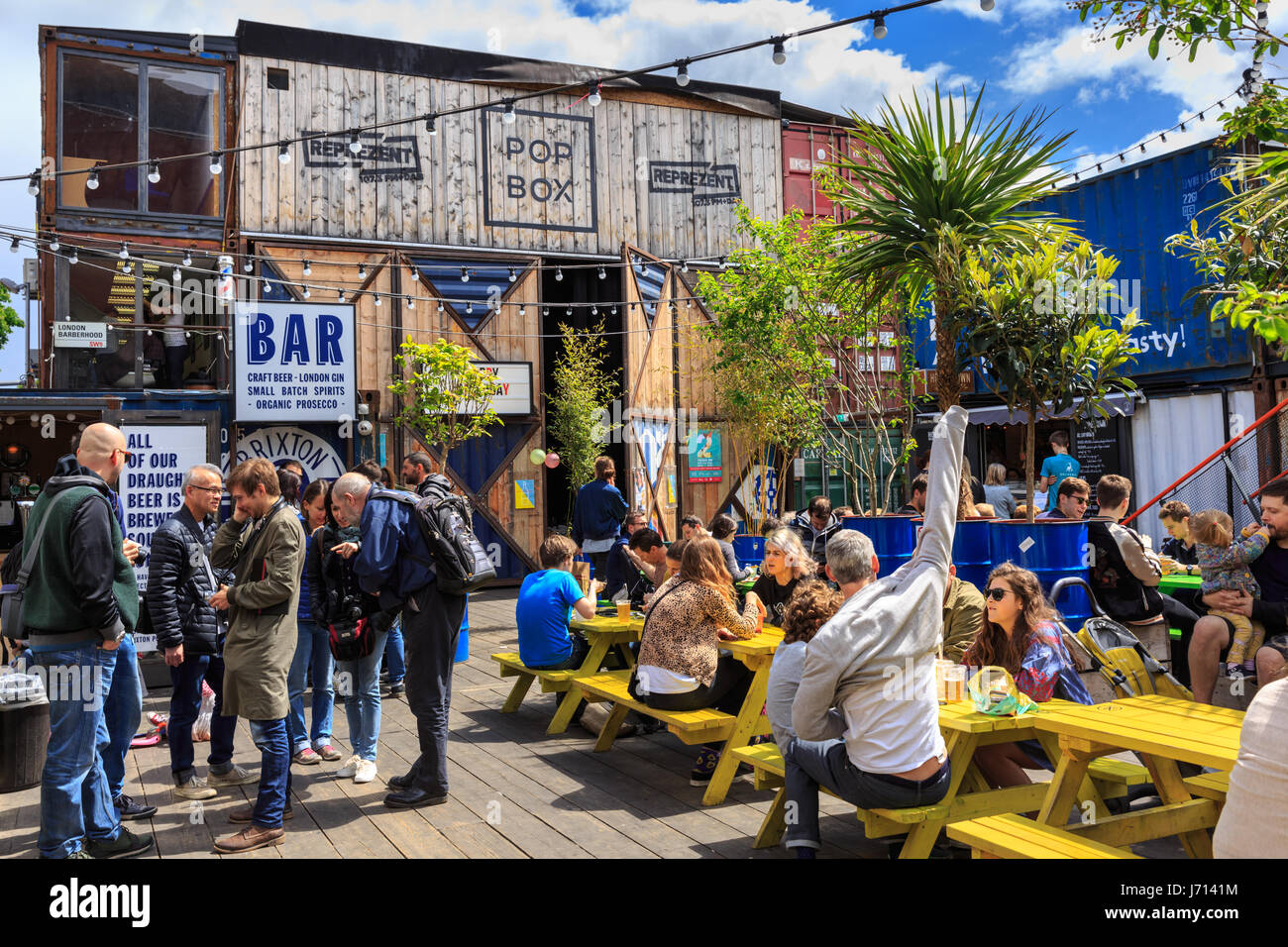 People enjoy a drink at Pop Brixton, pop up container bars and restaurants  in Brixton, London, UK Stock Photo - Alamy