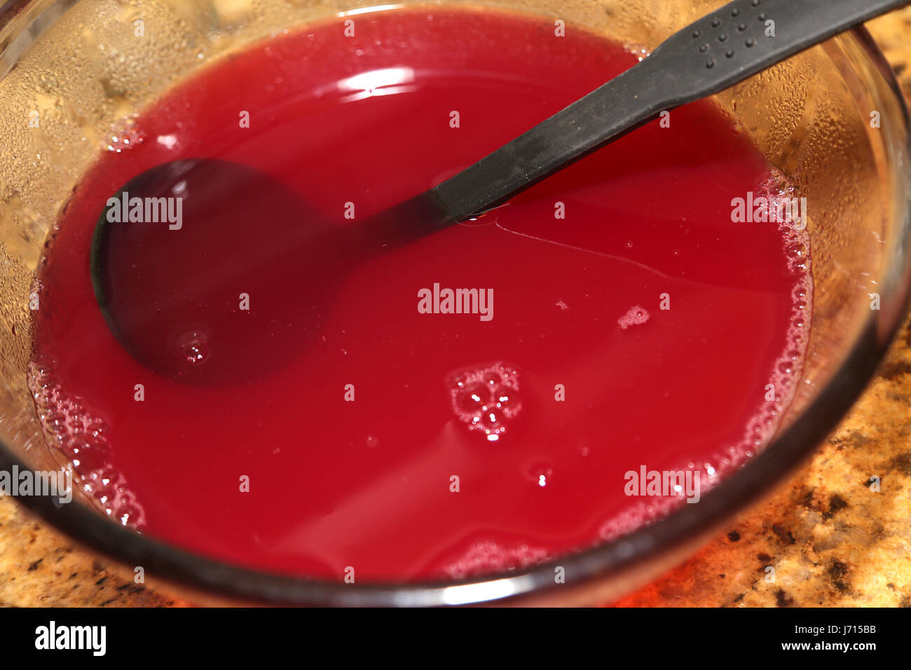 Making redcurrant jelly in glass bowl Stock Photo