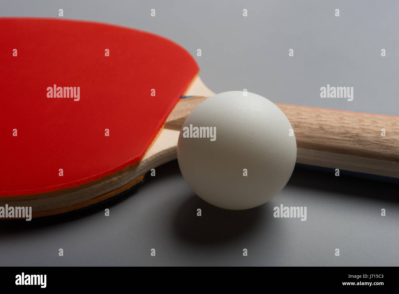 pingpong rackets and ball on a grey background Stock Photo