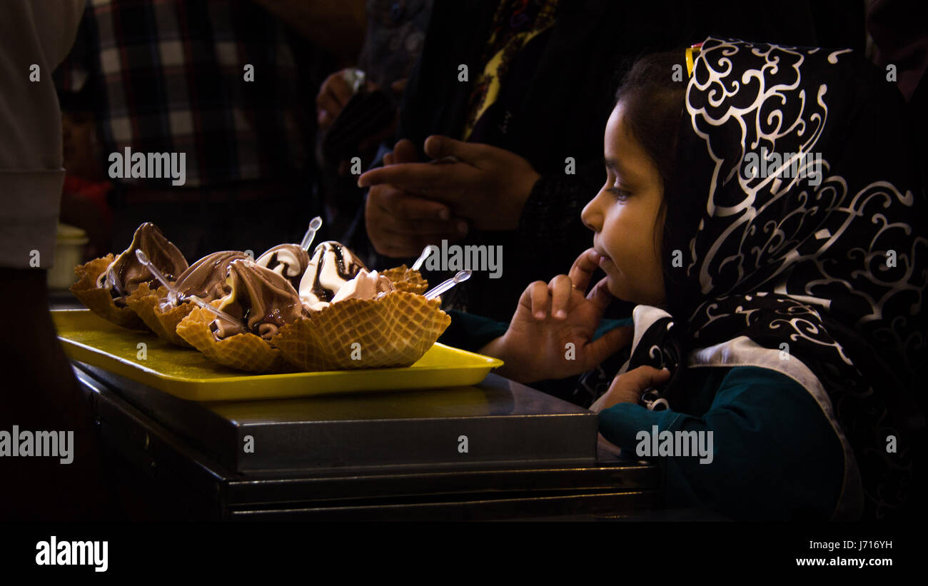 Girl having an ice cream in Naghsh-i Jahan Square, Esfahan, Iran Stock Photo