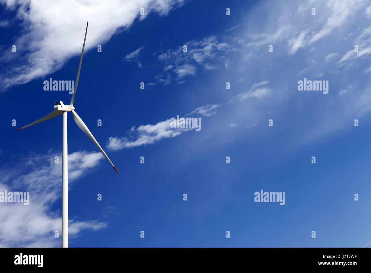 Wind turbine and blue sky with clouds at summer day Stock Photo - Alamy