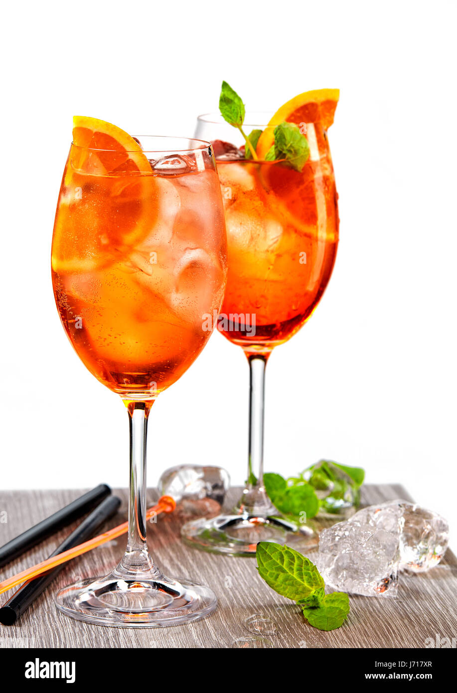 two glasses of aperol spritz cocktail and ice cubes on grey table Stock Photo